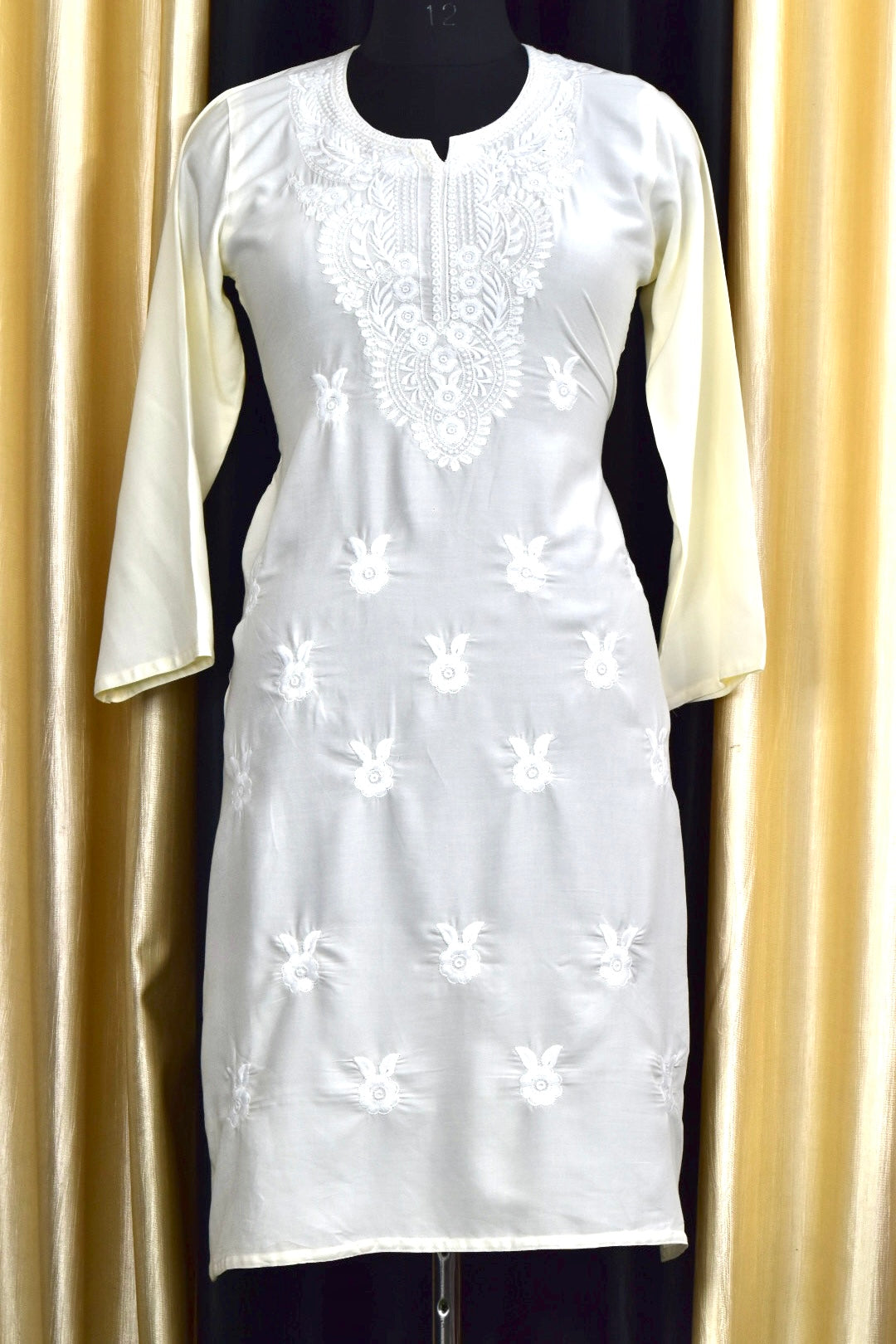 A-front-view-Vibrant white cotton kurti featuring intricate Chikankari embroidery, showcasing delicate floral patterns that add a traditional touch to a modern silhouette.