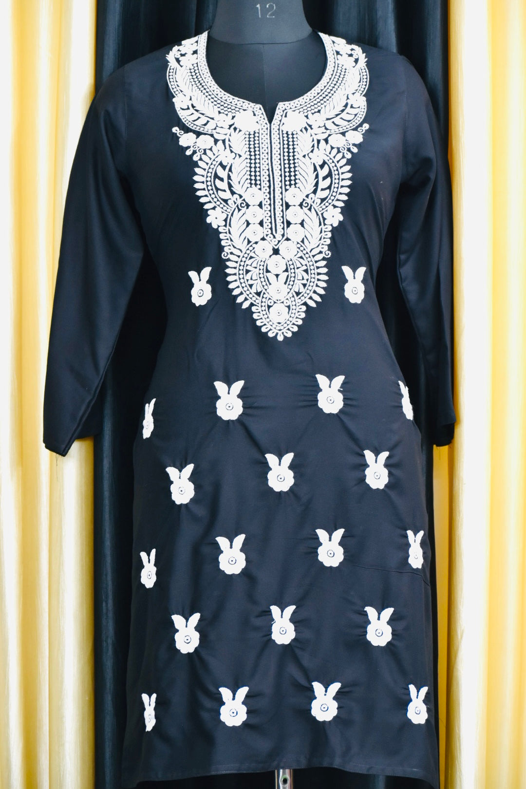 A-front-view-Vibrant Navi bluecotton kurti featuring intricate Chikankari embroidery, showcasing delicate floral patterns that add a traditional touch to a modern silhouette.