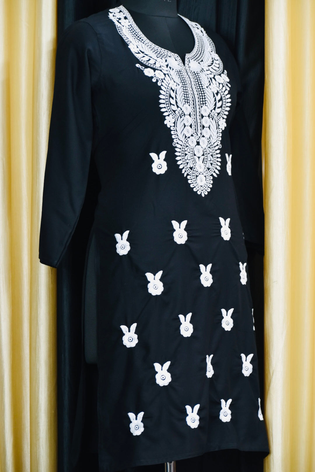 A-side-view-Vibrant Navi blue cotton kurti featuring intricate Chikankari embroidery, showcasing delicate floral patterns that add a traditional touch to a modern silhouette."