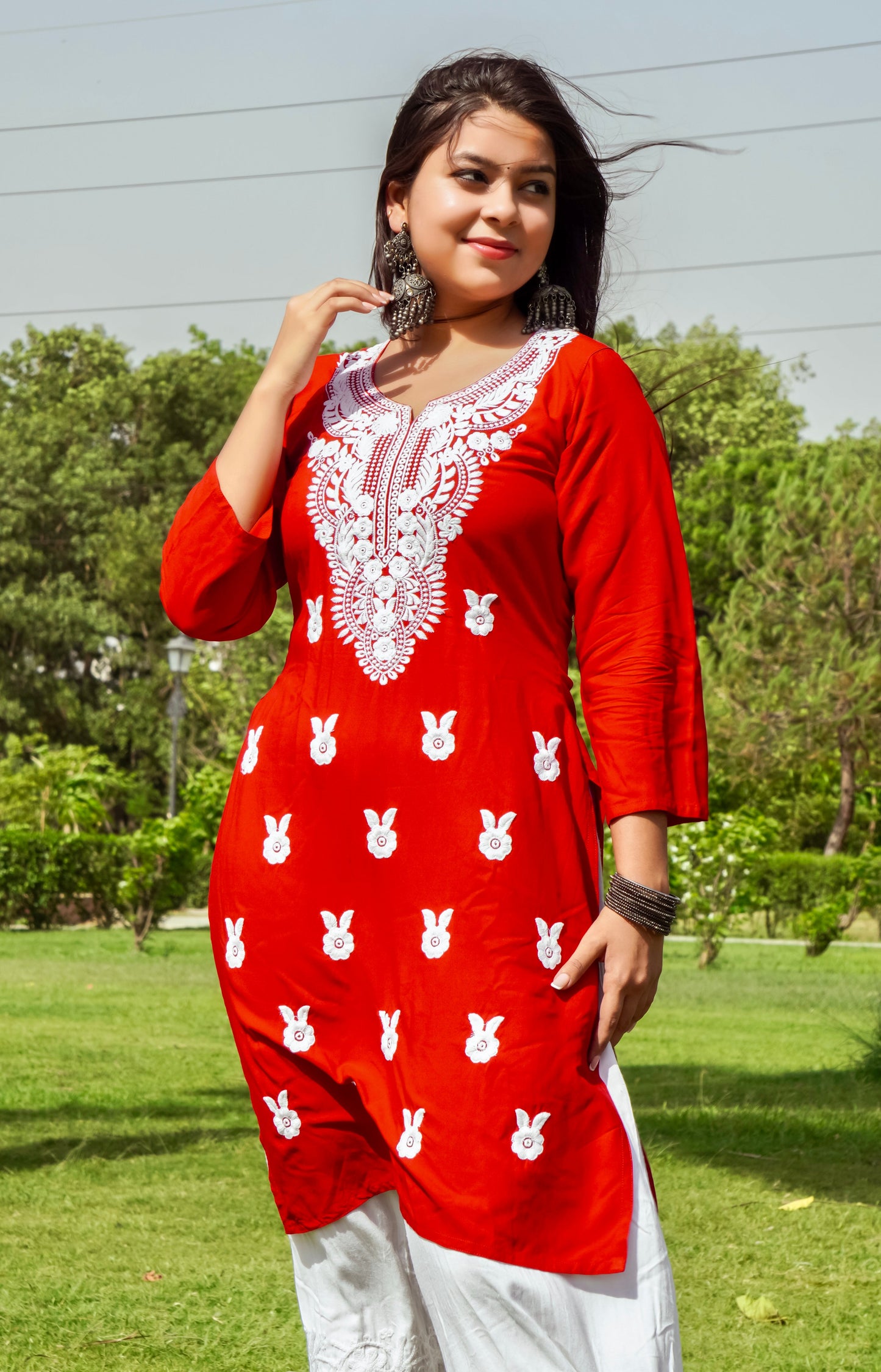 A-front-view-Vibrant red cotton kurti featuring intricate Chikankari embroidery, showcasing delicate floral patterns that add a traditional touch to a modern silhouette.