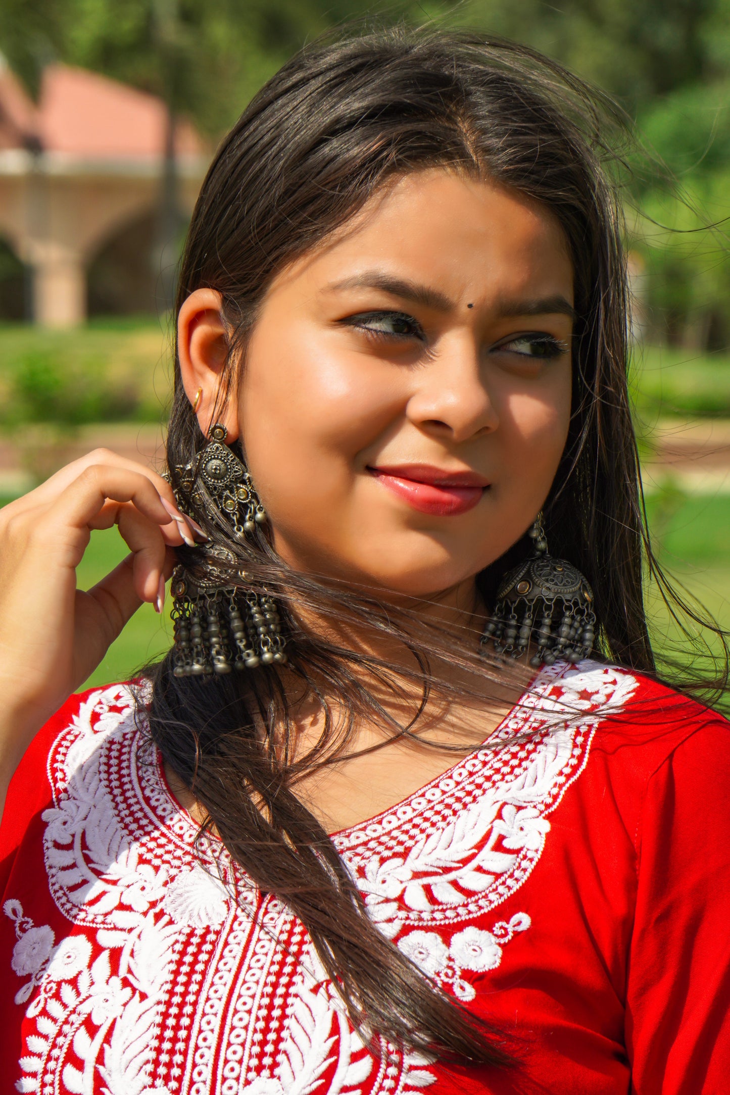 A-bottom-view-Vibrant red cotton kurti featuring intricate Chikankari embroidery, showcasing delicate floral patterns that add a traditional touch to a modern silhouette.