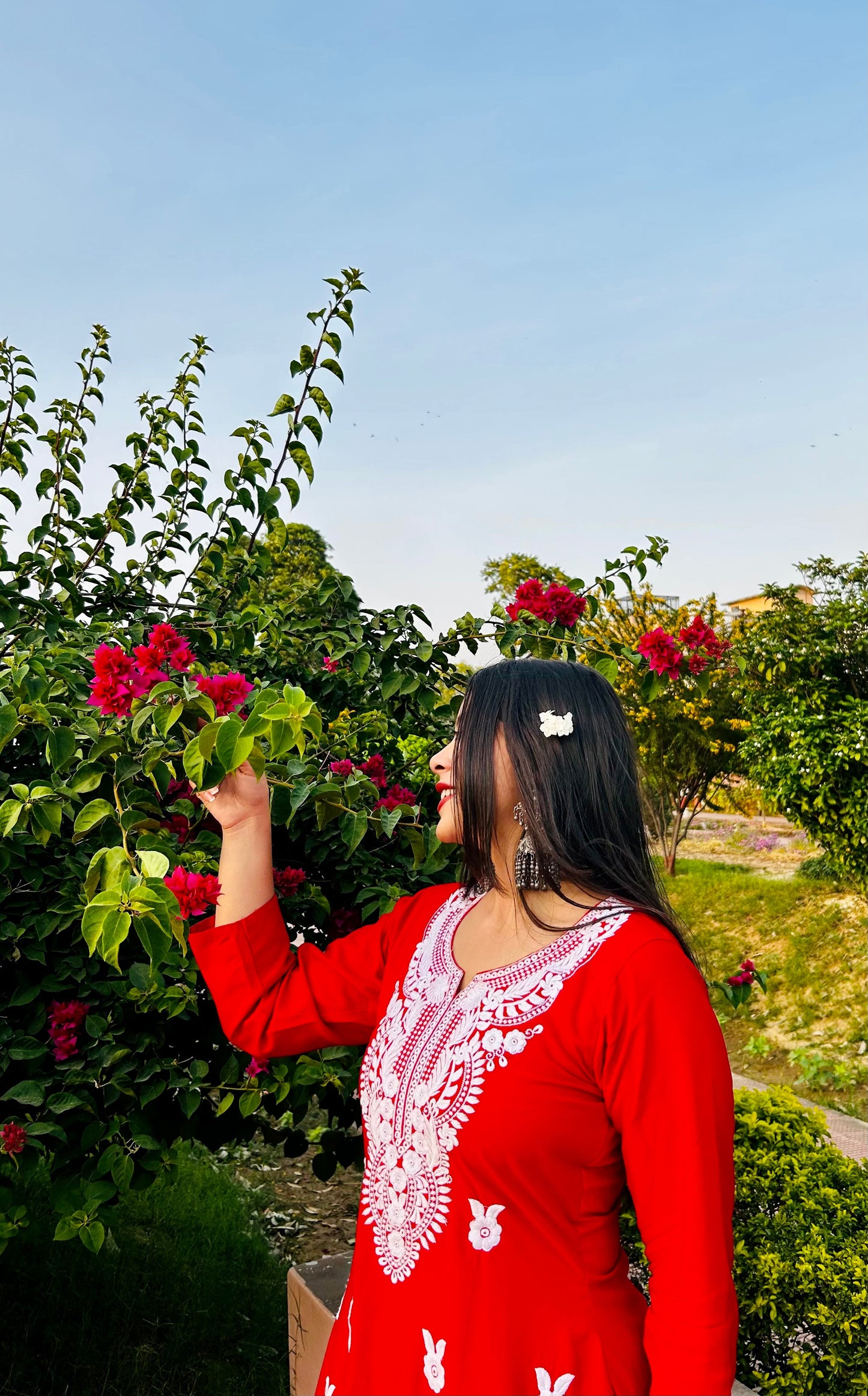 A-bottom-view-Vibrant red cotton kurti featuring intricate Chikankari embroidery, showcasing delicate floral patterns that add a traditional touch to a modern silhouette.