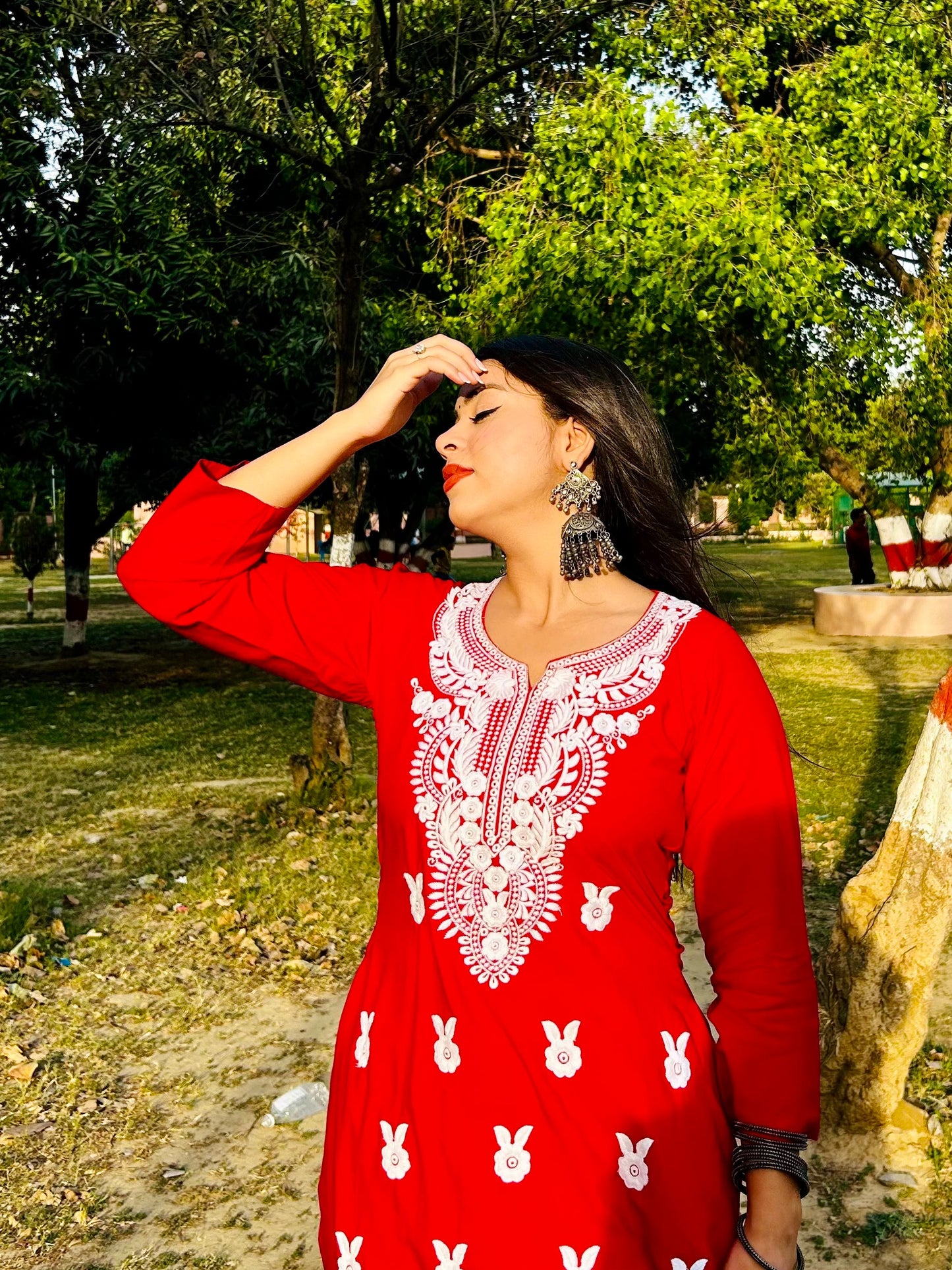 A-bottom-view-Vibrant red cotton kurti featuring intricate Chikankari embroidery, showcasing delicate floral patterns that add a traditional touch to a modern silhouette.