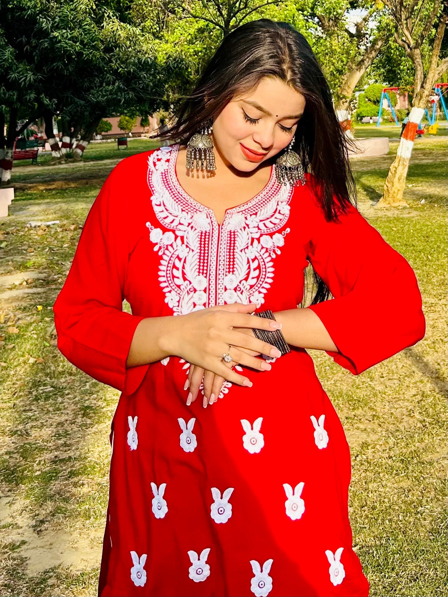 A-bottom-view-Vibrant red cotton kurti featuring intricate Chikankari embroidery, showcasing delicate floral patterns that add a traditional touch to a modern silhouette.