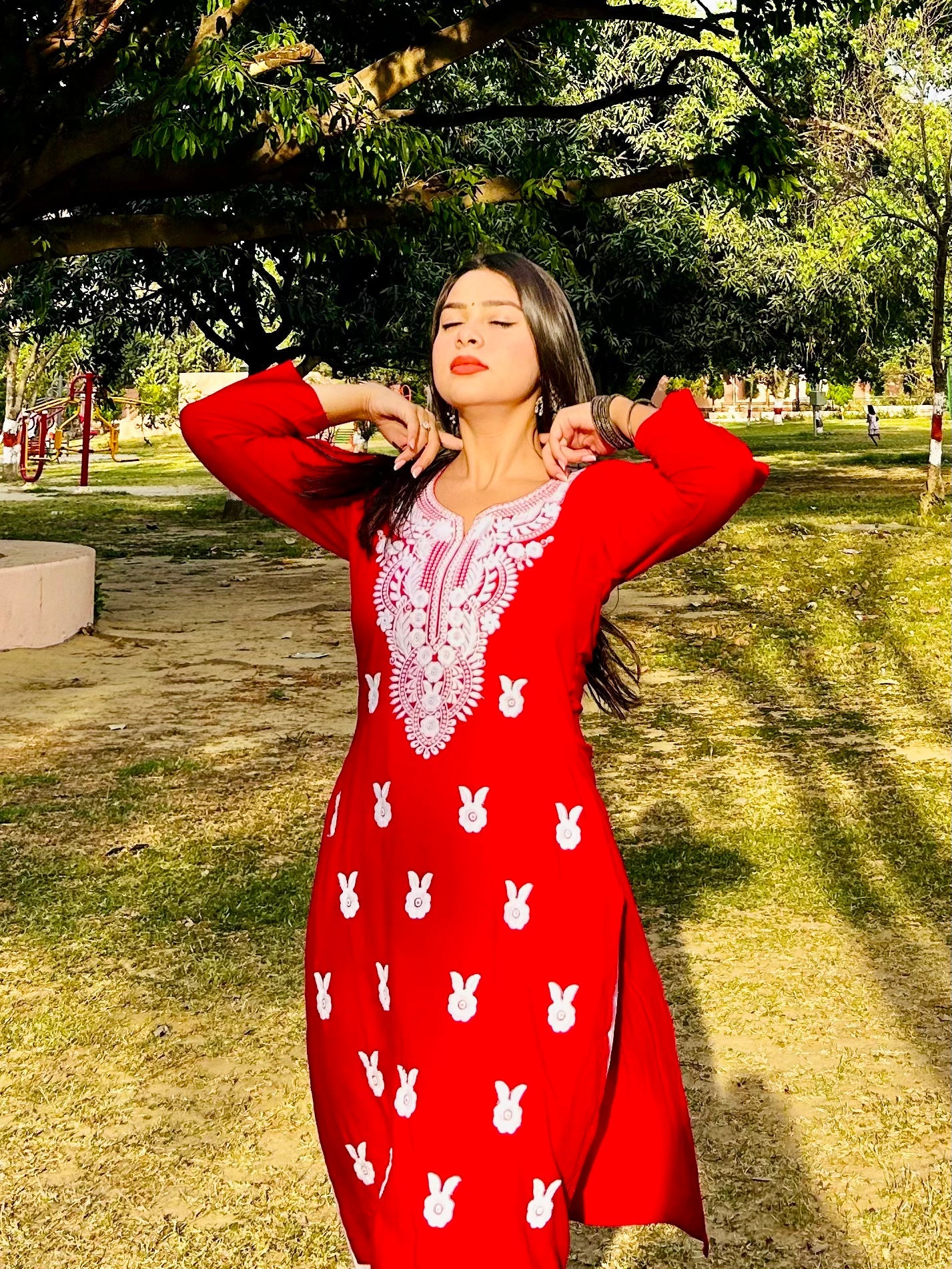 A-front-view-Vibrant red cotton kurti featuring intricate Chikankari embroidery, showcasing delicate floral patterns that add a traditional touch to a modern silhouette.